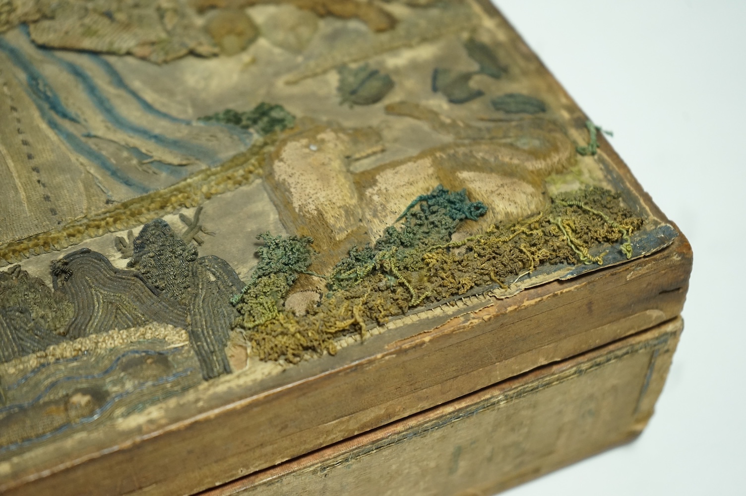 A late 17th century Charles II stump work box. The box originally embroidered to commemorate the marriage of Charles II to Catherine of Braganza in 1662. 31cm x 25.5cm deep., Condition - sadly during its 400 plus years o